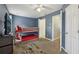 Bright bedroom with bunk beds, blue accent walls, and neutral carpeting at 7077 Biltmore Trce, Lithonia, GA 30058