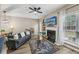 Cozy living room with a fireplace, large window, comfortable seating, and modern decor at 7077 Biltmore Trce, Lithonia, GA 30058