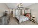 Spacious main bedroom with large canopy bed, carpeting, and a large dresser at 7077 Biltmore Trce, Lithonia, GA 30058