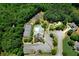 Aerial shot of a community pool, tennis courts, and playground surrounded by mature trees at 7251 Bluewater Ln, Douglasville, GA 30135