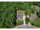 Aerial view of a home with lush trees, complemented by a long driveway and well-kept lawn at 7251 Bluewater Ln, Douglasville, GA 30135