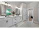 Bright bathroom featuring double vanity, white cabinets and black accents at 7251 Bluewater Ln, Douglasville, GA 30135