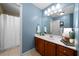 Bright bathroom with vanity and a shower/tub with white shower curtain at 7251 Bluewater Ln, Douglasville, GA 30135