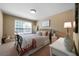 Cozy bedroom featuring a metal bed frame, soft bedding, a bedside table, and a window offering natural light at 7251 Bluewater Ln, Douglasville, GA 30135