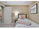 Cozy bedroom featuring carpet, a bed, nightstand, and a stylish 'enjoy' print on the wall at 7251 Bluewater Ln, Douglasville, GA 30135