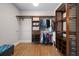 Spacious walk-in closet with custom shelving and wooden accents for organized storage at 7251 Bluewater Ln, Douglasville, GA 30135
