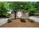 Whitestone community entrance sign made from stone, complemented by fresh landscaping and a well-kept road at 7251 Bluewater Ln, Douglasville, GA 30135