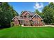Beautiful brick home with black shutters, lush landscaping and a well manicured lawn at 7251 Bluewater Ln, Douglasville, GA 30135