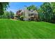 Two-story home with a well-manicured lawn, brick accents, and a charming backyard deck at 7251 Bluewater Ln, Douglasville, GA 30135