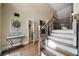 Inviting foyer with hardwood floors, staircase with iron railing, and natural light at 7251 Bluewater Ln, Douglasville, GA 30135