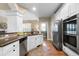 Modern kitchen features stainless steel appliances, granite counters and white cabinets at 7251 Bluewater Ln, Douglasville, GA 30135