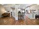 Open-concept kitchen featuring white cabinets, hardwood floors, and bar seating, perfect for entertaining guests at 7251 Bluewater Ln, Douglasville, GA 30135