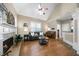 Cozy living room with a fireplace, leather sofa, and a vaulted ceiling with a fan, creating a comfortable atmosphere at 7251 Bluewater Ln, Douglasville, GA 30135