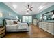 Stylish main bedroom with tray ceiling, hardwood floors, and large windows at 7251 Bluewater Ln, Douglasville, GA 30135