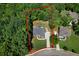 Aerial view showcasing a tree-surrounded property, with distinct property lines highlighted in red at 7251 Bluewater Ln, Douglasville, GA 30135