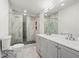 Modern bathroom featuring gray vanity, elegant tile and glass enclosed shower at 2155 Venetian Sw Dr, Atlanta, GA 30311