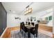 Dining area with hardwood floors, modern lighting, and a view of the living room at 2155 Venetian Sw Dr, Atlanta, GA 30311