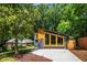 Exterior side view highlighting its contemporary design, wooden window accents, and landscaping at 2155 Venetian Sw Dr, Atlanta, GA 30311