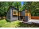 Striking modern home featuring a unique design, gray siding, and contrasting wooden window frames at 2155 Venetian Sw Dr, Atlanta, GA 30311