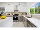 Well-lit kitchen with stainless steel appliances, granite countertops, and stylish backsplash at 2155 Venetian Sw Dr, Atlanta, GA 30311
