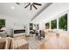 Bright living room featuring a fireplace, vaulted ceiling, and large windows with a view of the outdoors at 2155 Venetian Sw Dr, Atlanta, GA 30311