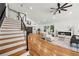 Bright and spacious living room featuring hardwood floors, fireplace, stairs and modern decor at 2155 Venetian Sw Dr, Atlanta, GA 30311
