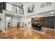 Open-concept living and dining area with hardwood floors, modern decor, and a view of the second-floor loft at 2155 Venetian Sw Dr, Atlanta, GA 30311