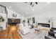Spacious living room showcasing hardwood floors, fireplace, and open floor plan leading to dining area at 2155 Venetian Sw Dr, Atlanta, GA 30311