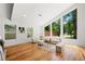 Bright living room featuring a high ceiling, hardwood floors, and large windows with a view of the outdoors at 2155 Venetian Sw Dr, Atlanta, GA 30311
