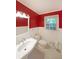 Bright bathroom featuring a white sink and tiling with a window for plenty of natural light at 295 Lakemont Dr, Roswell, GA 30075