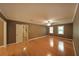 Spacious bedroom boasting hardwood floors, two windows, and a ceiling fan at 295 Lakemont Dr, Roswell, GA 30075