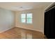Bedroom boasting hardwood floors, a window with a view, and a walk-in closet at 295 Lakemont Dr, Roswell, GA 30075