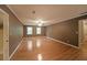 Expansive bedroom featuring hardwood floors, two windows, and a ceiling fan at 295 Lakemont Dr, Roswell, GA 30075