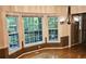 Sunlit dining area with a bay window offering serene outdoor views and a decorative chandelier at 295 Lakemont Dr, Roswell, GA 30075