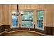 Bright dining room featuring a bay window with scenic outdoor views and an elegant chandelier at 295 Lakemont Dr, Roswell, GA 30075