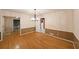Bright dining room featuring hardwood floors, wainscoting, modern chandelier and multiple entry points at 295 Lakemont Dr, Roswell, GA 30075