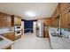 Large kitchen with wood cabinets, tile floor, marble counters, stainless steel appliances, and blue accent walls at 295 Lakemont Dr, Roswell, GA 30075
