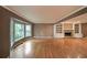 Spacious living room featuring a brick fireplace, built-in shelving, large windows, and gleaming hardwood floors at 295 Lakemont Dr, Roswell, GA 30075