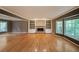 Bright living room featuring a brick fireplace, built-in shelving, and large windows with natural light at 295 Lakemont Dr, Roswell, GA 30075