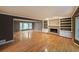 Spacious living room featuring hardwood floors and a brick fireplace with built-in shelving at 295 Lakemont Dr, Roswell, GA 30075