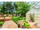 Backyard featuring a wooden deck, a greenhouse, and lush landscaping at 529 Arnold Rd, Lawrenceville, GA 30044