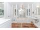 Bright bathroom features a soaking tub with chandeliers and lots of natural light at 529 Arnold Rd, Lawrenceville, GA 30044