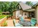 Backyard deck with outdoor seating, grill, and view of greenhouse at 529 Arnold Rd, Lawrenceville, GA 30044