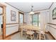 Dining room with wood trim, hardwood floors, with a wooden table and four chairs, bathed in natural light at 529 Arnold Rd, Lawrenceville, GA 30044