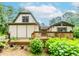 Back of charming home featuring a spacious wooden deck and lovely garden area at 529 Arnold Rd, Lawrenceville, GA 30044