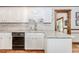 Modern kitchen boasts white cabinets, stone countertops, hardwood floors, and an open layout at 529 Arnold Rd, Lawrenceville, GA 30044