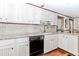 Cozy kitchen features white cabinets, stone countertops, stainless appliances, and hardwood floors offering space at 529 Arnold Rd, Lawrenceville, GA 30044