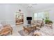 Spacious living room with ceiling fan, natural light, floral seating, and view to the dining area at 529 Arnold Rd, Lawrenceville, GA 30044