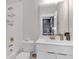 Bathroom featuring a tiled shower, modern fixtures, and a sleek white vanity at 687 Banton Nw Dr, Atlanta, GA 30318
