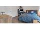 Bedroom with a gaming setup featuring hardwood floors, a large window, and comfortable bed at 687 Banton Nw Dr, Atlanta, GA 30318